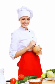 Young cook preparing food wearing a red apron