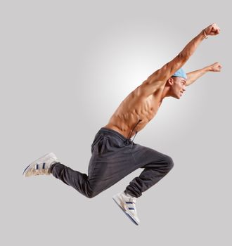 young man in a blue cap dancing hip hop