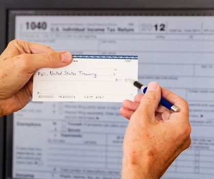 Electronic tax form 1040 for 2012 for US individual return on screen with check payable to US Treasury
