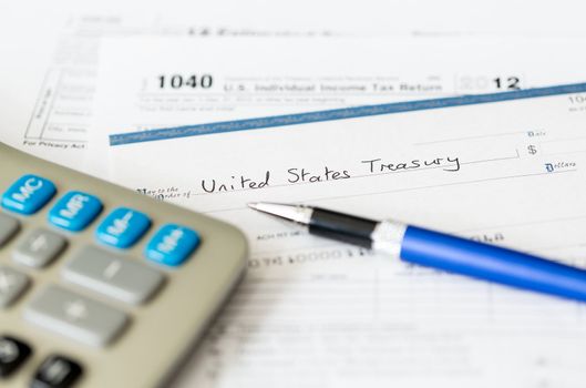 Tax form 1040 for tax year 2012 for US individual tax return with pen and check