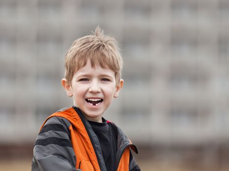 Little cheerful child boy walking outdoor and smiling for happiness and fun