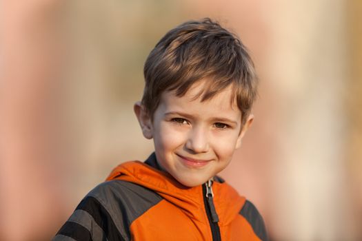 Little cheerful child boy walking outdoor and smiling for happiness and fun