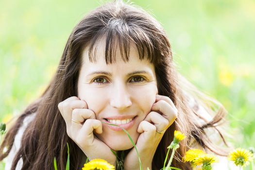 Beauty young smiling caucasian woman walking outdoor on flowers field