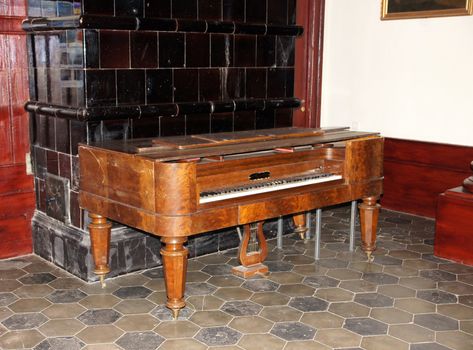 The old harpsichord costs in a room at a wall