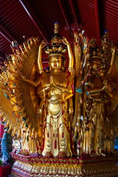 Closeup photo of thousands gold hands statue