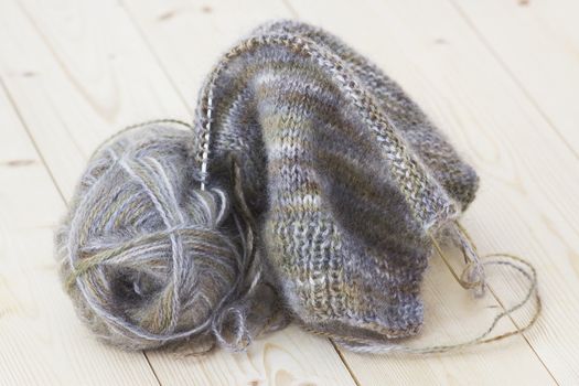 Woollen thread and knitting needle.