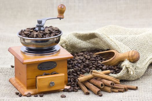 cinnamon sticks, coffee beans and coffee grinder 