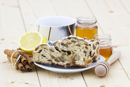 christmas stollen, honey, lemon and cinnamon sticks
