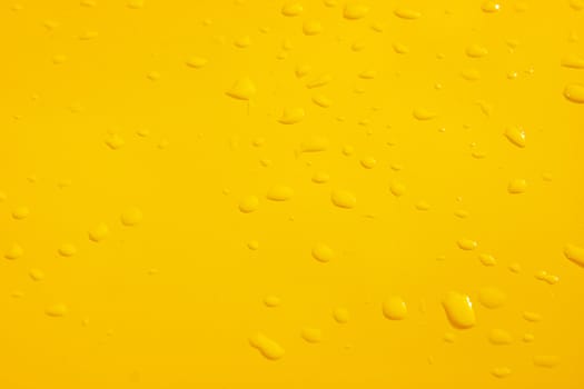 raindrops on the surface painted in yellow metal