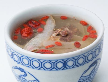 Chicken and herb soup in pot, Chinese food style.