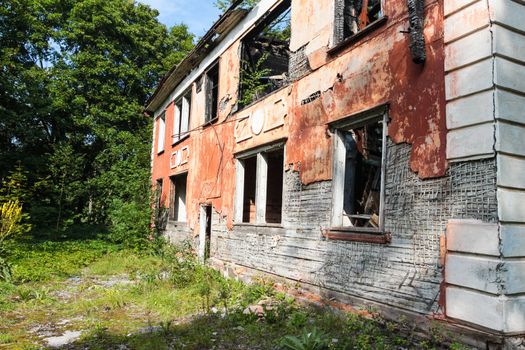 Farmhouse ruin among rural landscape