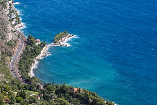 French Riviera with windy road, turquoise sea and villa from the top of mountain. France, Europe