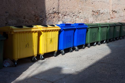 three type of plastic big trash recycling bins on the street