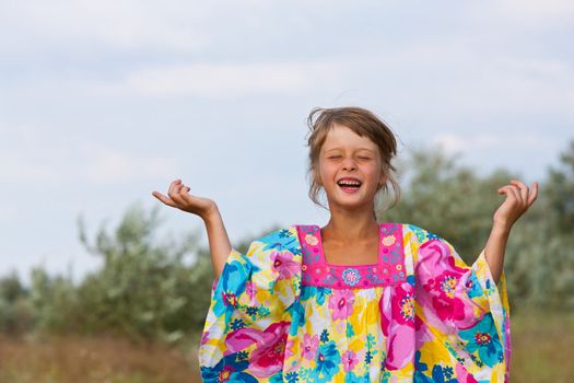 happy little girl are dancing on the field