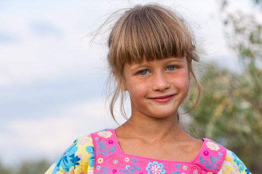 happy little girl are posing on the field