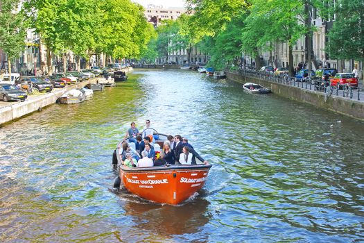 Tourists on a boat in Amsterdam, Netherlands