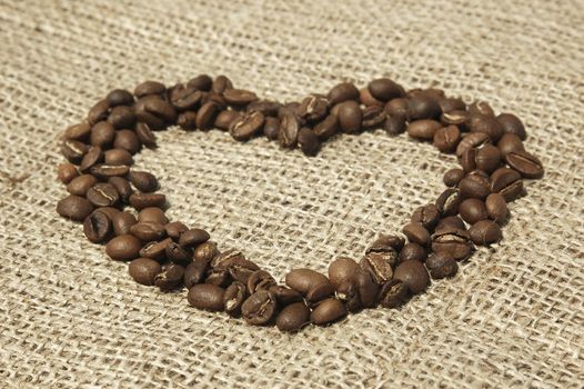 Heart shaped Coffee beans on canvas background