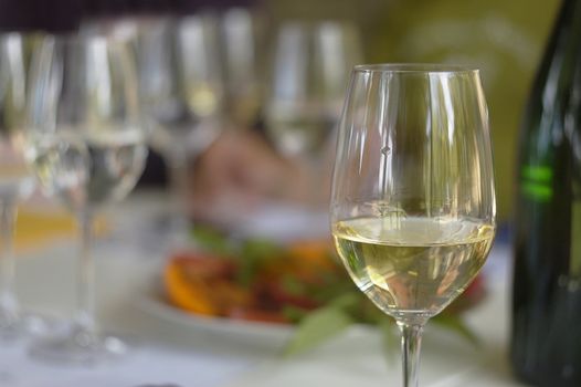 Closeup glass of white wine over blurred background. Crimean region, Ukraine