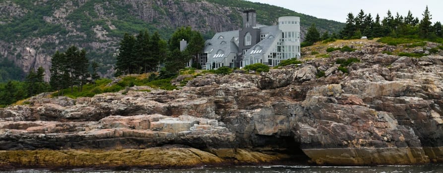 A home on the ocean in Maine. Shown along the rocky coasr