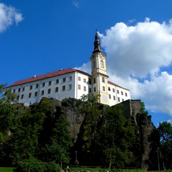        Medieval Czech castle standing on the rock with blue sky