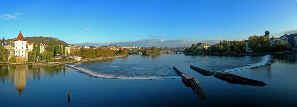 Panoramatic photo of the city of Prague with a view at Vltava River and Castle