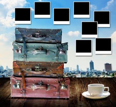 Travel memories concept, Vintage travel bag and photo frame with city view background