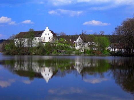           Old water castle in the middle of a large lake