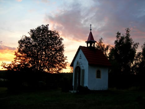           Lonsome chapel in the fields by sunset time