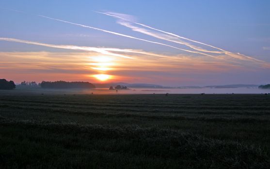 Field after the harvest at sunrise