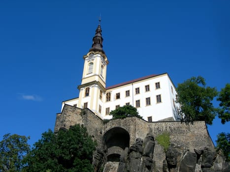        Medieval Czech castle standing on the rock with blue sky