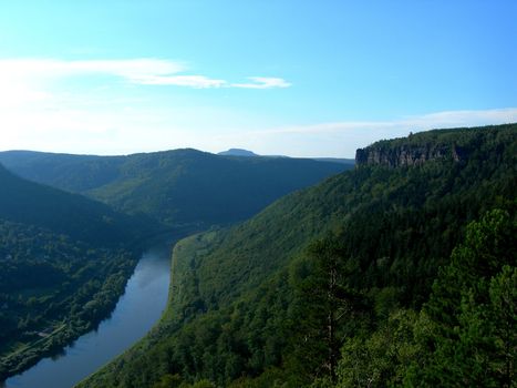           River Vltava in horshoe band and mountains with forests