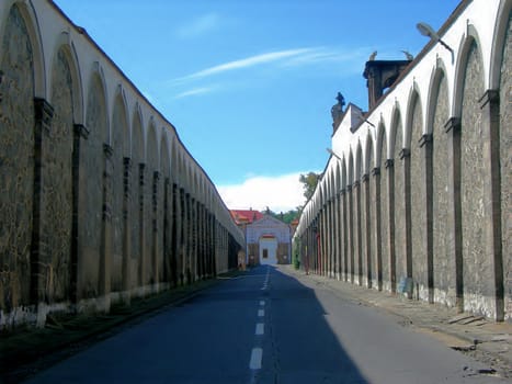  Road which is surrounded by old massive walls         