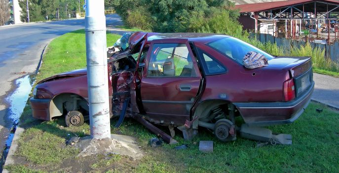          Red car after the terrible accident - it crashed into a pillar 