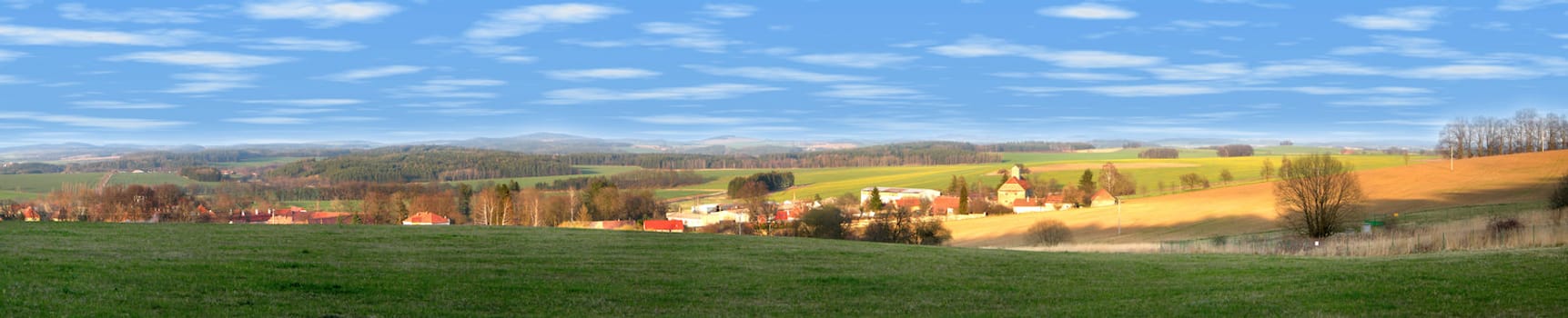 Landscape of a czech county - village with hiils, pastures and fields