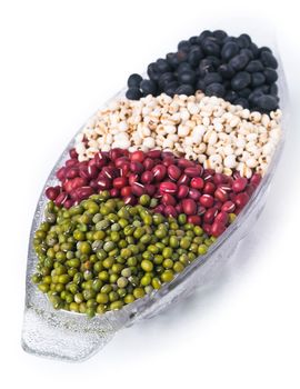 red beans, green beans and black beans on background