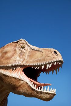 Aggressive T-Rex close-up on a blue sky