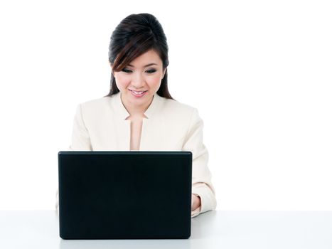 Portrait of a cute young businesswoman using laptop on white background.