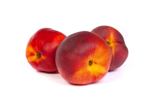 Three fresh nectarines isolated on a white background