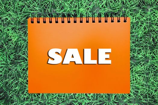 Sale sign on grass background