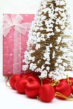 perspective of red holiday box with christmas tree and ornament