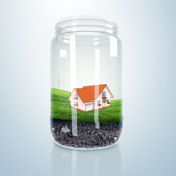 Residential house with red roof inside glass jar