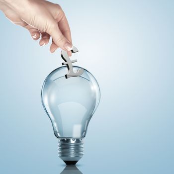 Hand and money inside an electric light bulb