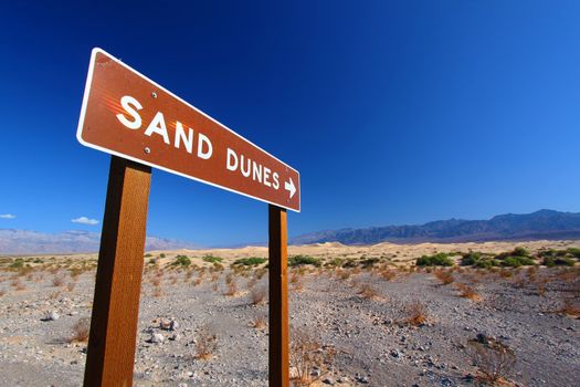 Sign in Death Valley National Park pointing out location of the Mesquite Flat Sand Dunes for visitors.