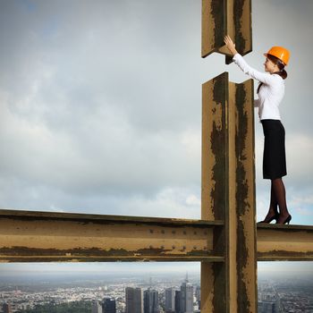 Business woman standing high over a cityscape