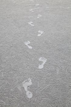 Footprint on the gray sand beach