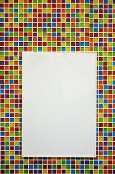 Blank paper board with plastic frame on colorful mosaic wall
