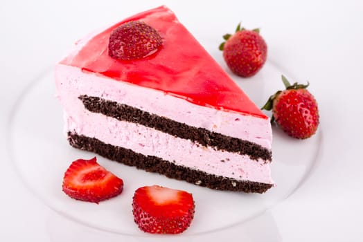Strawberries and chocolate cake on the plate.