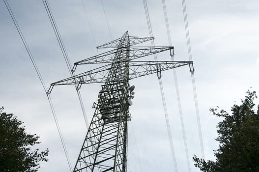 high voltage power electricity pylons under sky
