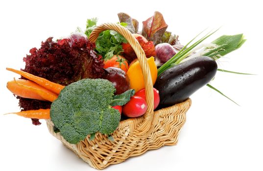 Basket of Various Vegetables with Broccoli, radishes, lettuce, onions, leeks, beets, carrots, red tomatoes, yellow tomatoes, parsley isolated on white background