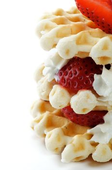 Waffles with Strawberries and Whipped Cream close up isolated on white background